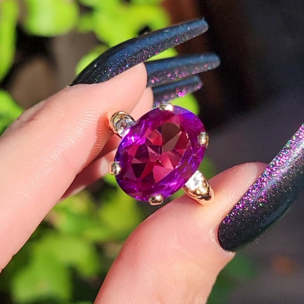 I don't know about you, but sometimes I just can't decide what color to choose. This beautiful simulated sapphire understands. You'll see color changes from deep purple to fuchsia. If that wasn't enough color for you, the center stone is flanked by blue topaz side stones. No matter what color mood you're in, this shifty ring has got you covered. Don't miss it!