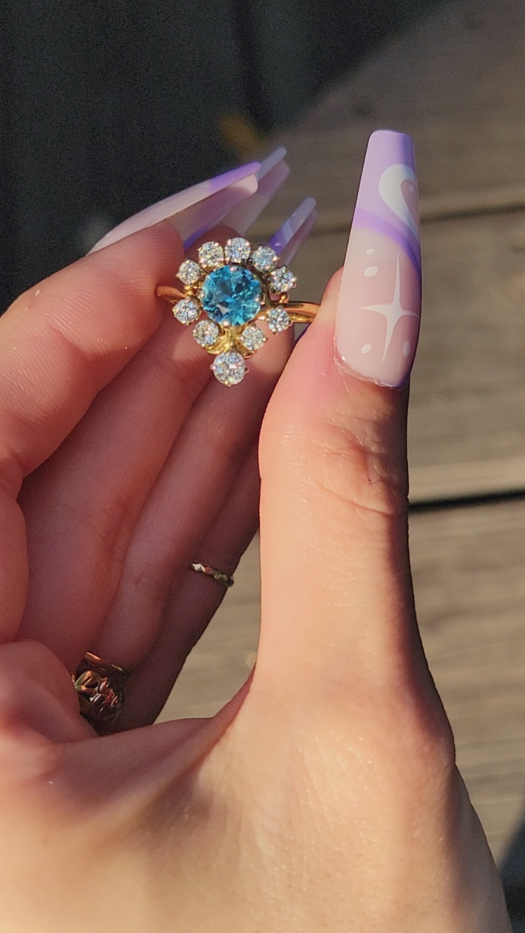 Pictures do not do this princess justice. This stunner is crafted in 18kt yellow gold and she is truly exquisite. The way the diamonds capture the light will surely cast rainbows all around you. The large blue topaz center stone is light and beautiful, but frequently photographs darker than eye sees. We know you will feel like royalty rocking this princess, so we aptly named her the Tiara.