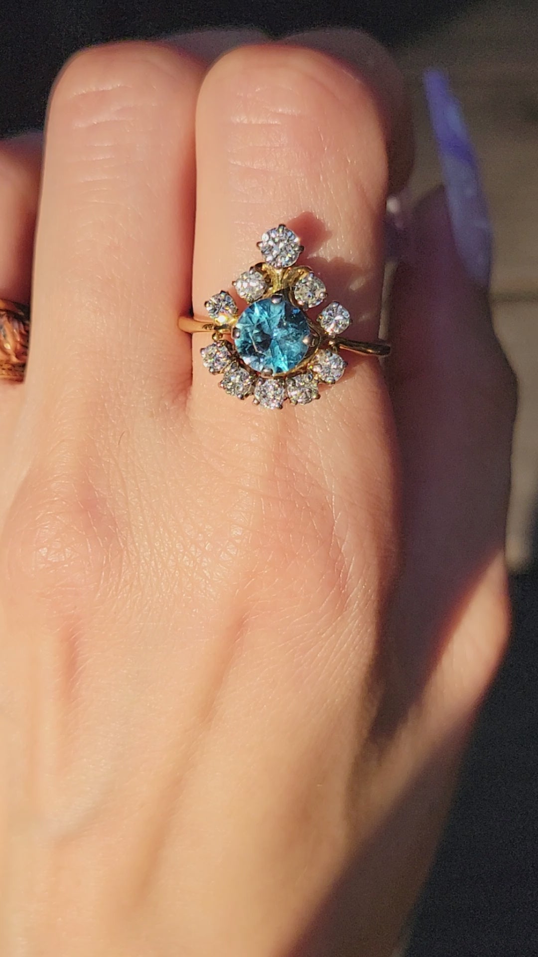 Pictures do not do this princess justice. This stunner is crafted in 18kt yellow gold and she is truly exquisite. The way the diamonds capture the light will surely cast rainbows all around you. The large blue topaz center stone is light and beautiful, but frequently photographs darker than eye sees. We know you will feel like royalty rocking this princess, so we aptly named her the Tiara.