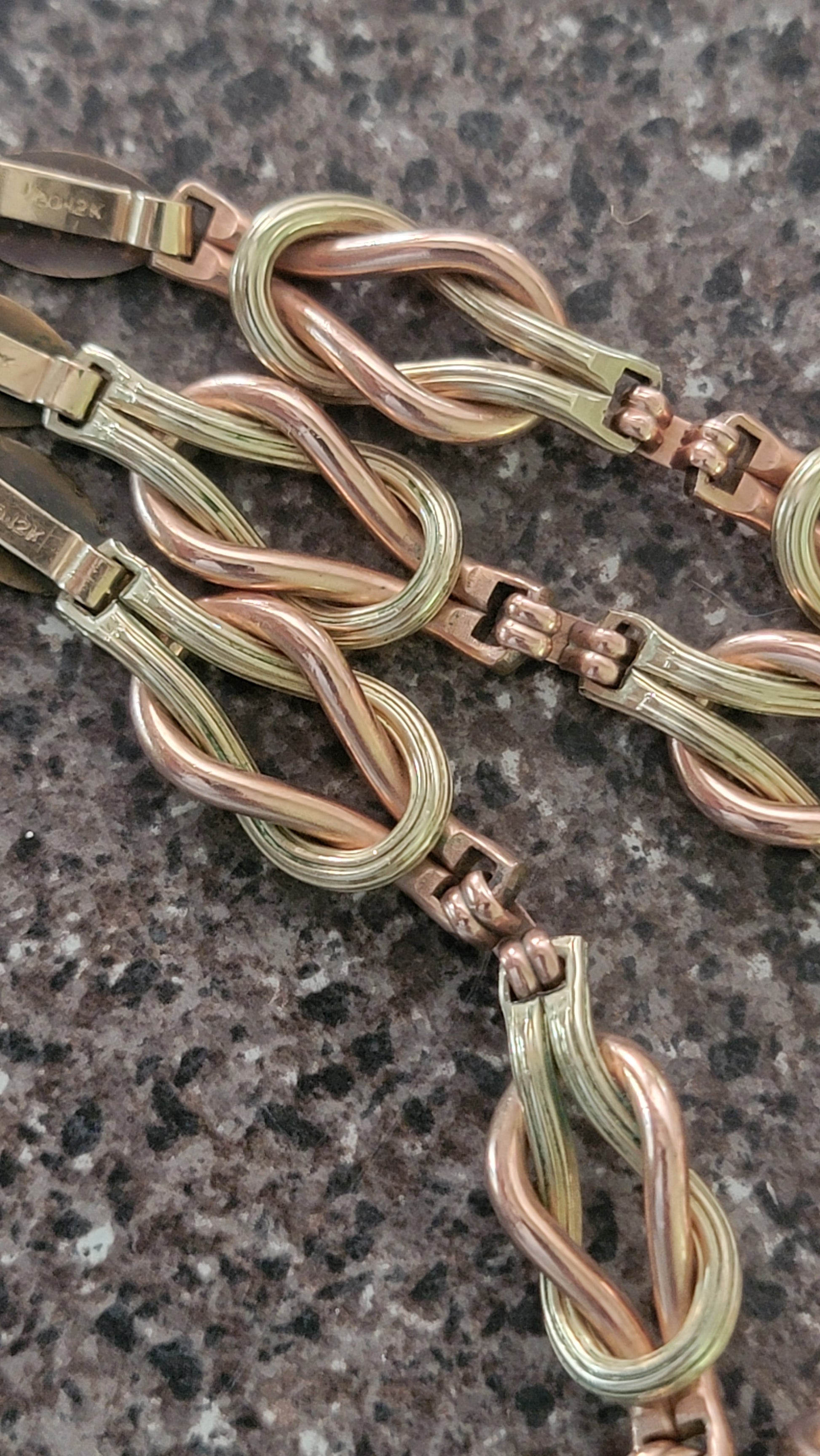 Your beautiful necklace is a 12k gold filled piece. It has green, rose, and yellow gold. The links are both textured/polished finish.  The entire set can be connected or worn as separate pieces. 