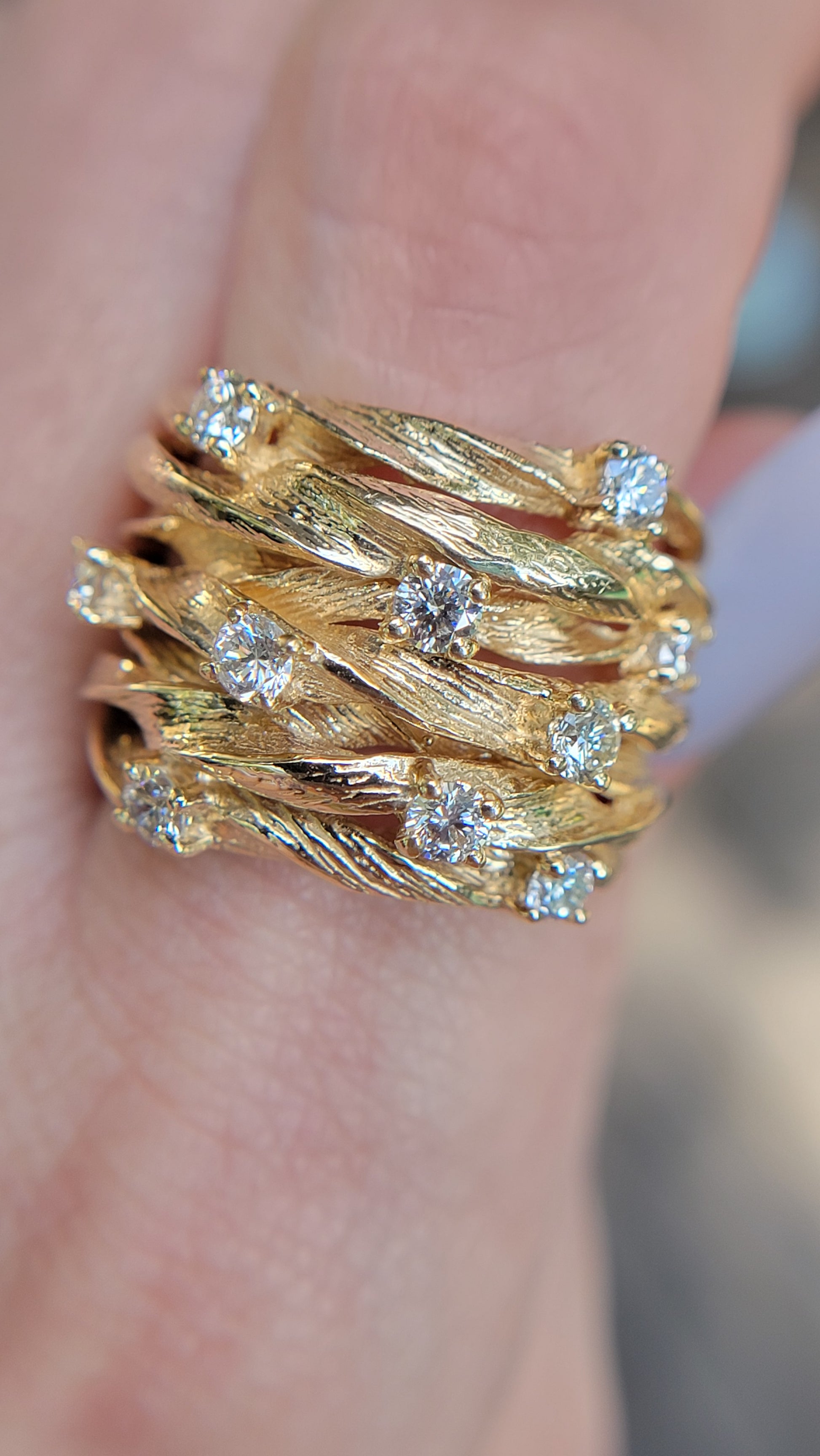 Gold ring with diamonds on a finger