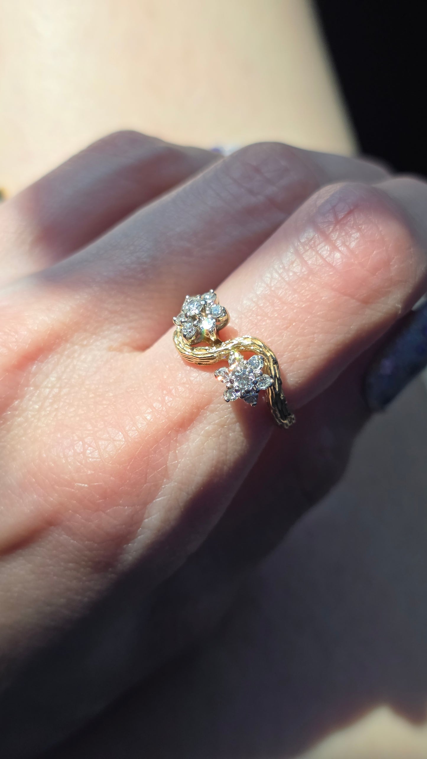 Close-up of a hand wearing diamond ring on a blurred background