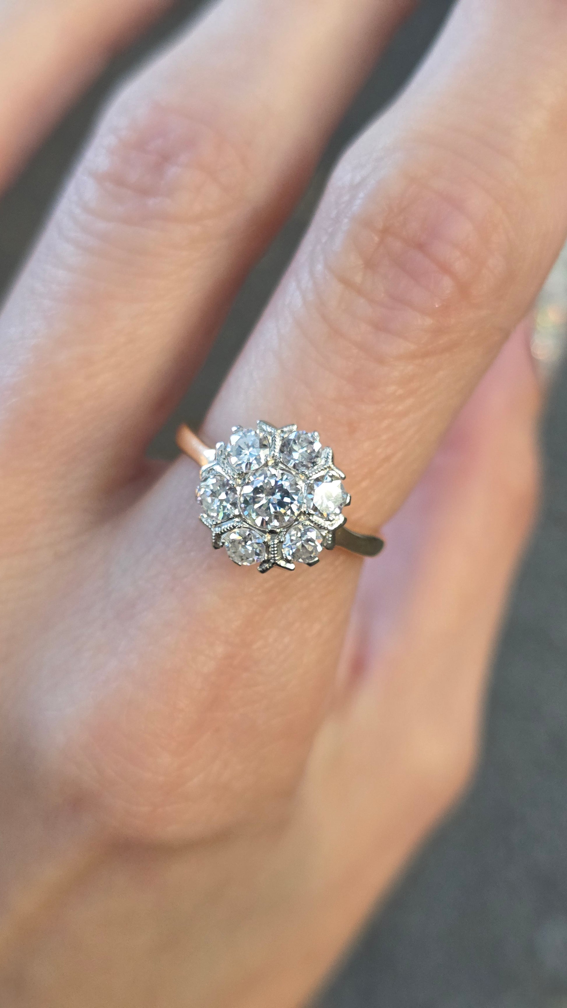 Diamond ring on a finger with a blurred background