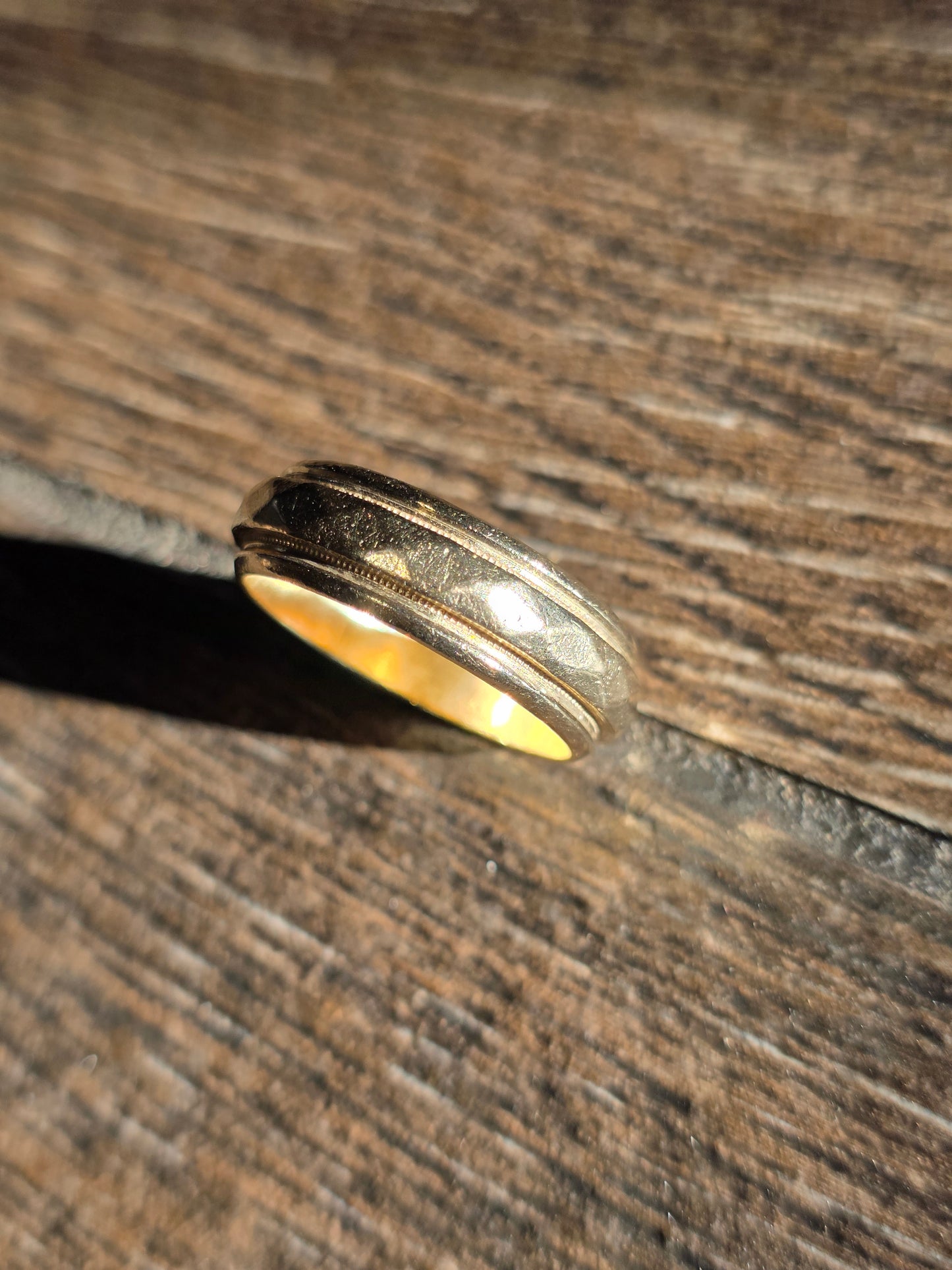 Gold ring on a wooden surface
