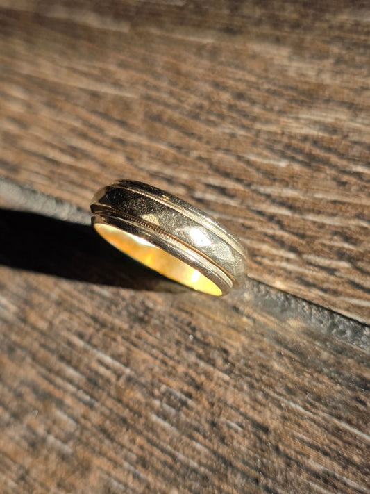 Gold ring on a wooden surface
