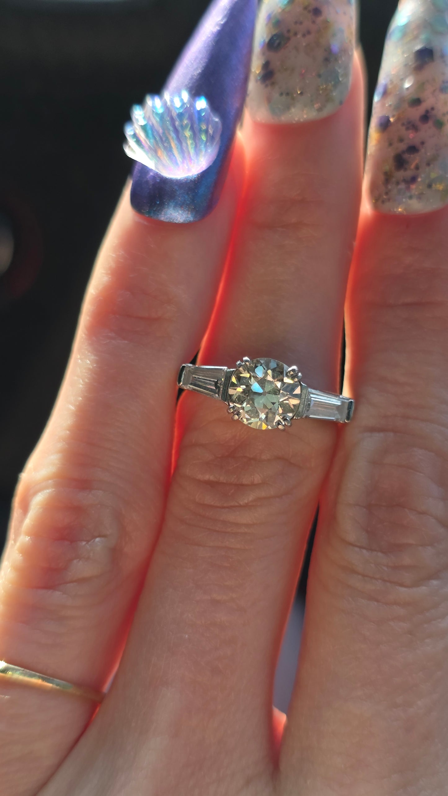 Diamond ring on a finger with a blurred background
