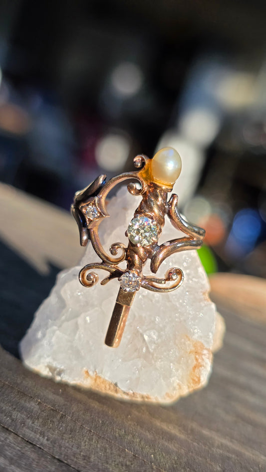 Ornate ring with pearls and gemstones on a stone surface