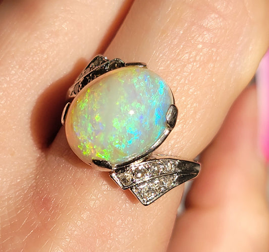 Words really cannot begin to describe this kaleidoscopic Opal. A whopper of an oval cab, set in a 14kt bypass setting with diamonds. Likely custom made in the 1940's. The setting reminds me of a pilot's wings.
